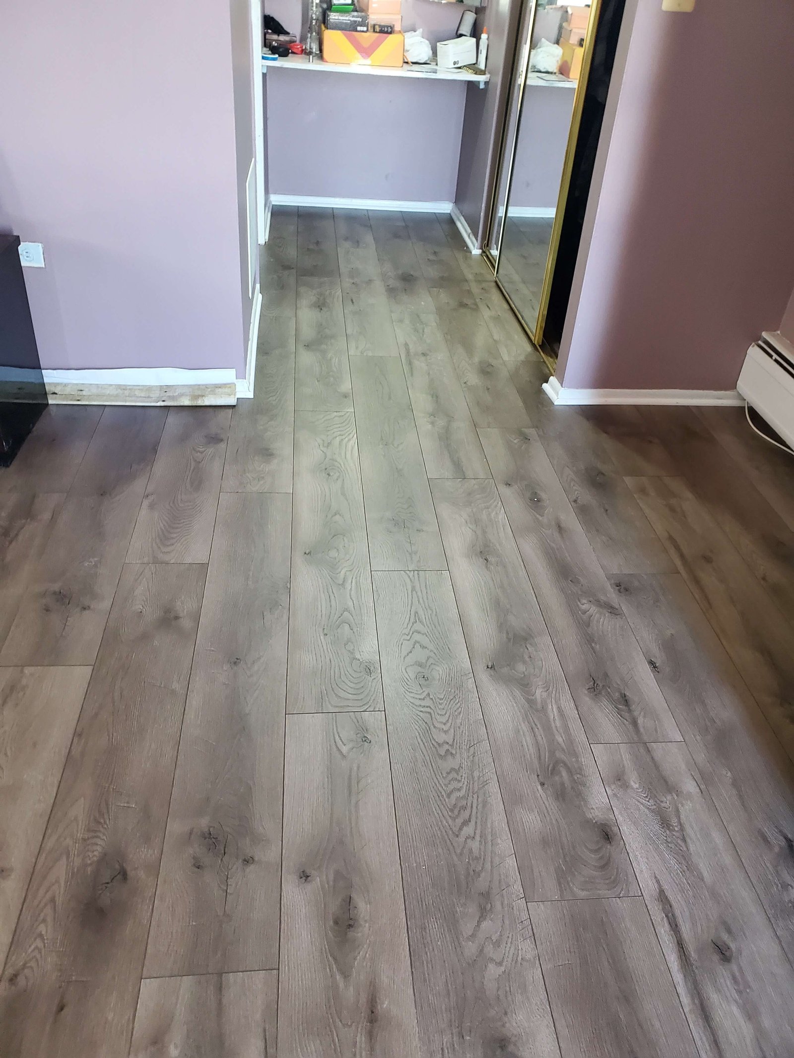 Hardwood flooring installation across bedroom and hallway areas
